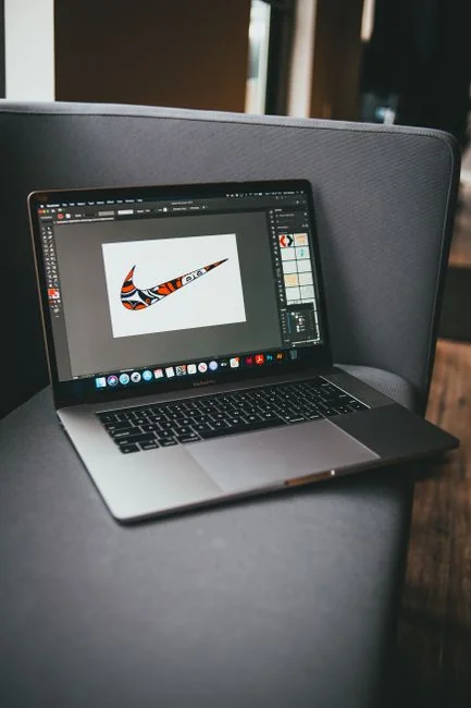 A modern computer screen displaying web design work, showcasing creative visuals in a workspace.